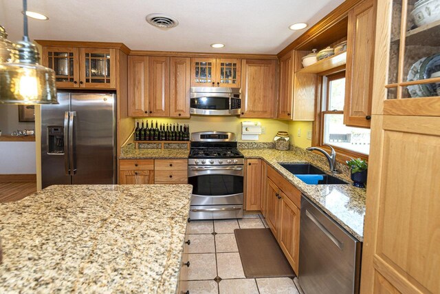 W340S2401 County Road C, Oconomowoc, WI 53066 - kitchen featuring stainless steel appliances, brown cabinetry, visible vents, and a sink