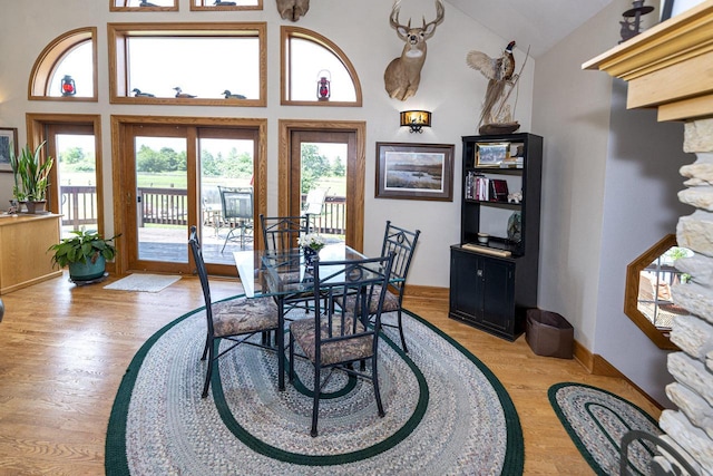 W340S2401 County Road C, Oconomowoc, WI 53066 - dining area with high vaulted ceiling, light wood finished floors, and baseboards
