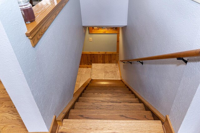 W340S2401 County Road C, Oconomowoc, WI 53066 - staircase featuring a textured wall and wood finished floors