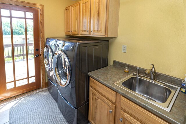 W340S2401 County Road C, Oconomowoc, WI 53066 - laundry room featuring separate washer and dryer, a sink, and cabinet space