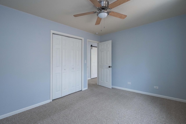 unfurnished bedroom featuring a closet, ceiling fan, baseboards, and carpet floors