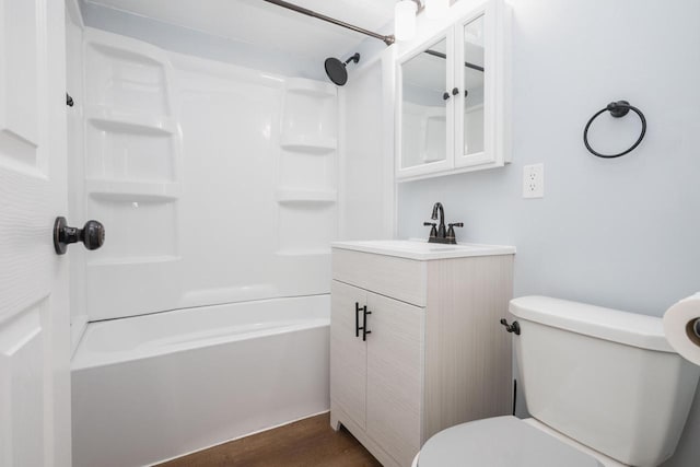 bathroom with shower / bath combination, vanity, toilet, and wood finished floors