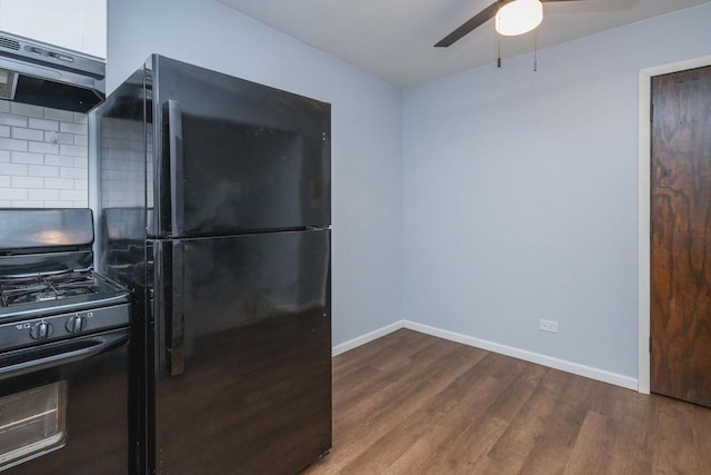 kitchen featuring ceiling fan, tasteful backsplash, black appliances, under cabinet range hood, and wood finished floors