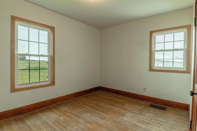 N1616 Haddinger Rd, Monroe, WI 53566 - spare room with hardwood / wood-style floors and baseboards