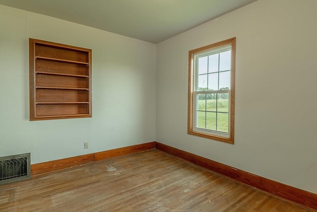 N1616 Haddinger Rd, Monroe, WI 53566 - unfurnished room featuring baseboards and wood finished floors