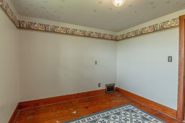 N1616 Haddinger Rd, Monroe, WI 53566 - laundry area featuring hardwood / wood-style flooring and baseboards