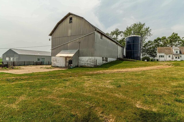 N1616 Haddinger Rd, Monroe, WI 53566 - back of house featuring a barn, an outbuilding, and a yard