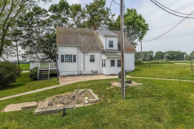 N1616 Haddinger Rd, Monroe, WI 53566 - rear view of house with a wooden deck, a patio area, a yard, and a chimney