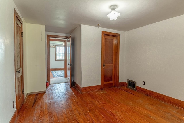 N1616 Haddinger Rd, Monroe, WI 53566 - unfurnished room with hardwood / wood-style flooring and baseboards