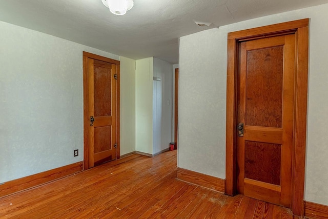 N1616 Haddinger Rd, Monroe, WI 53566 - unfurnished room with wood finished floors and baseboards