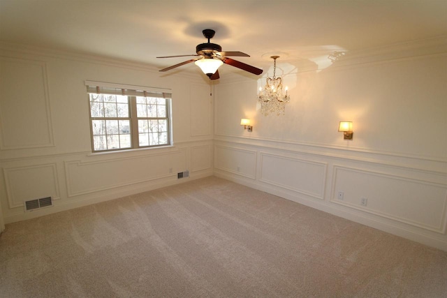 4786 Cardinal Ln, Sun Prairie, WI 53590 - empty room with visible vents, ornamental molding, light carpet, a decorative wall, and ceiling fan with notable chandelier