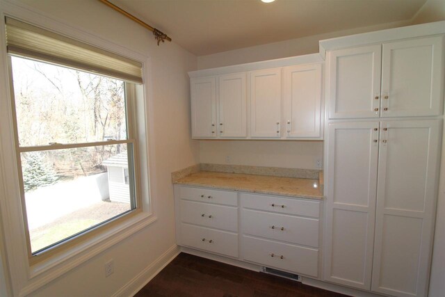 4786 Cardinal Ln, Sun Prairie, WI 53590 - interior space featuring plenty of natural light, baseboards, white cabinetry, and dark wood finished floors