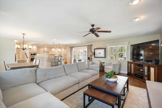4786 Cardinal Ln, Sun Prairie, WI 53590 - living room with recessed lighting, wood finished floors, baseboards, and ceiling fan with notable chandelier