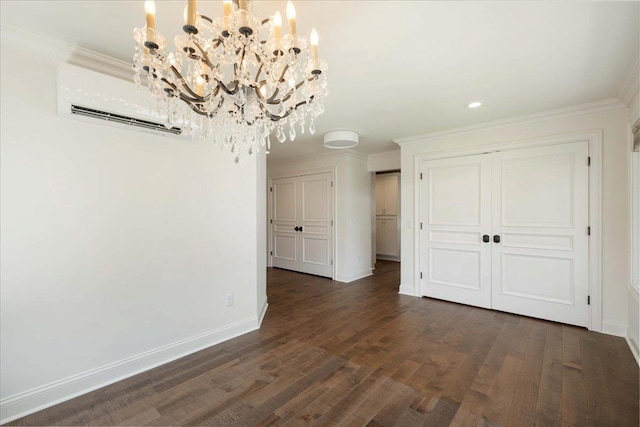 4786 Cardinal Ln, Sun Prairie, WI 53590 - unfurnished dining area featuring a notable chandelier, dark wood finished floors, baseboards, ornamental molding, and a wall unit AC
