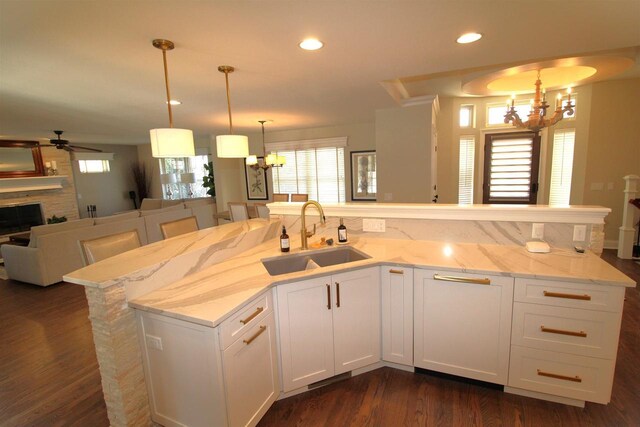 4786 Cardinal Ln, Sun Prairie, WI 53590 - kitchen with ceiling fan with notable chandelier, light stone countertops, open floor plan, and a sink