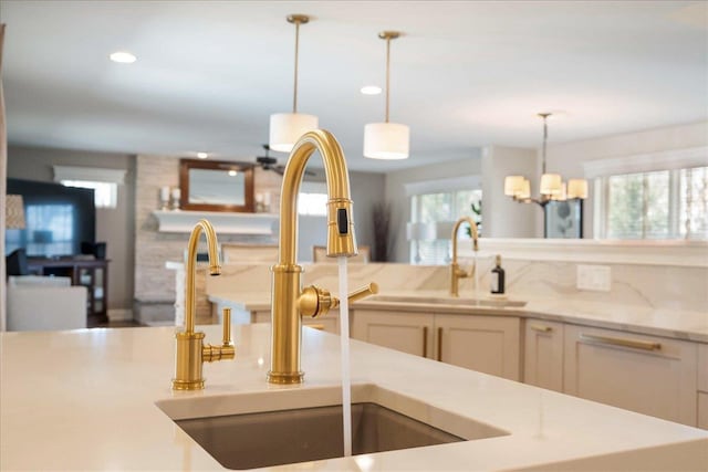 4786 Cardinal Ln, Sun Prairie, WI 53590 - kitchen with white cabinets, recessed lighting, pendant lighting, and a sink