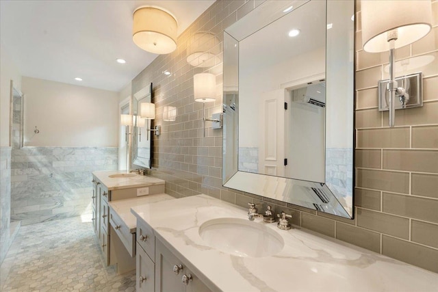 4786 Cardinal Ln, Sun Prairie, WI 53590 - full bath featuring two vanities, tile walls, tile patterned flooring, and a sink