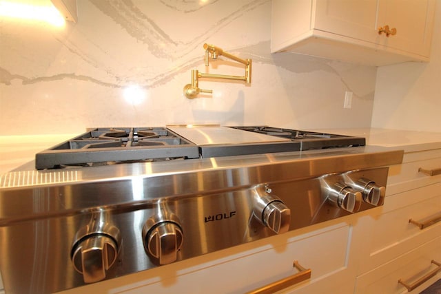 4786 Cardinal Ln, Sun Prairie, WI 53590 - room details featuring light countertops, tasteful backsplash, range, and white cabinetry