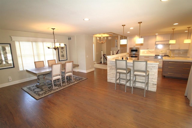 4786 Cardinal Ln, Sun Prairie, WI 53590 - dining space with dark wood-style floors, visible vents, baseboards, an inviting chandelier, and recessed lighting