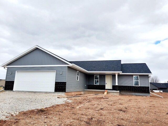 1710 Fairlawn Ave, North Fond Du Lac, WI 54937 - ranch-style house with an attached garage, roof with shingles, and gravel driveway