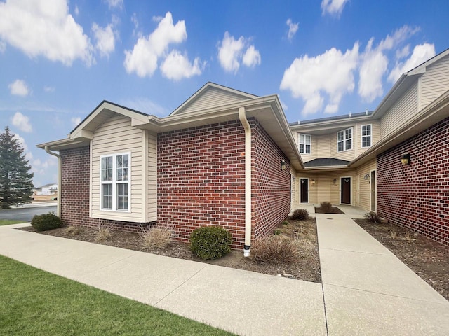 view of side of property with brick siding