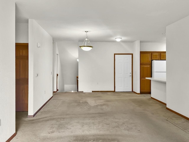interior space featuring light carpet and baseboards