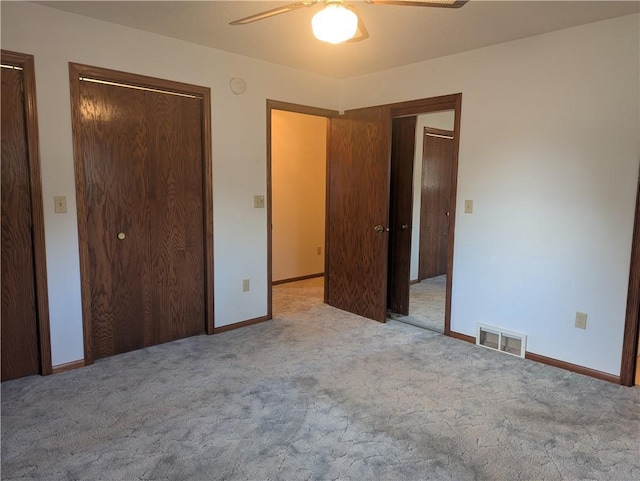 1024 24th St, Chetek, WI 54728 - unfurnished bedroom with carpet flooring, baseboards, visible vents, and multiple closets
