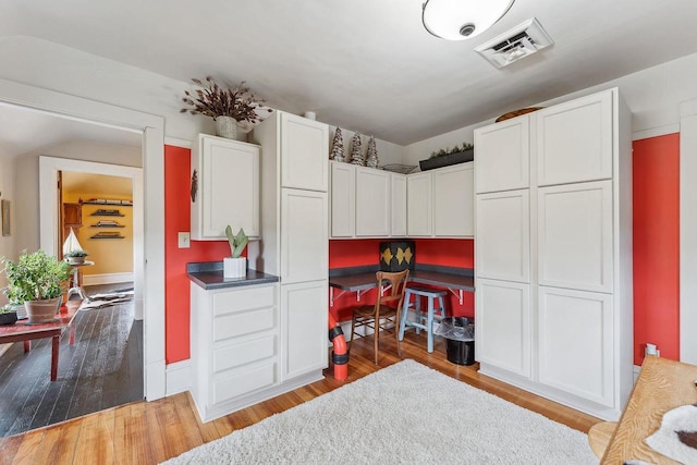 E3625 Wilkinson Rd, La Valle, WI 53941 - kitchen with white cabinets, visible vents, and wood finished floors