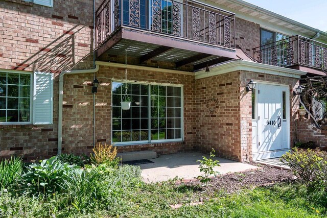 3410 Valley Ridge Rd Unit 1, Middleton, WI 53562 - entrance to property featuring brick siding, a balcony, and a patio area