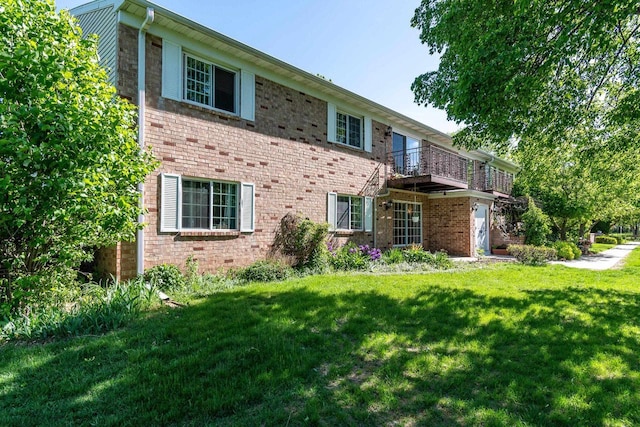 3410 Valley Ridge Rd Unit 1, Middleton, WI 53562 - view of front of house with brick siding, a front yard, and a balcony