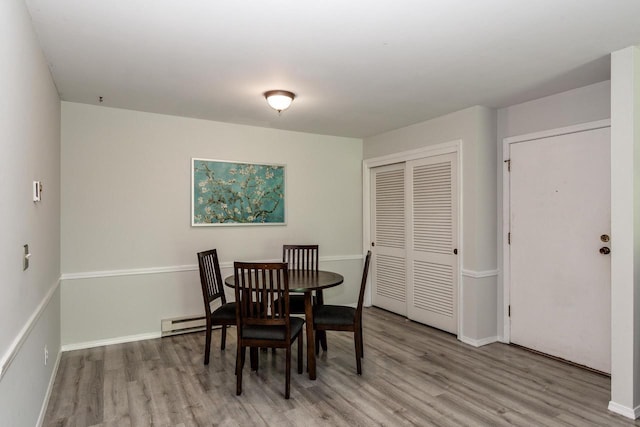 3410 Valley Ridge Rd Unit 1, Middleton, WI 53562 - dining room with wood finished floors, baseboards, and a baseboard radiator