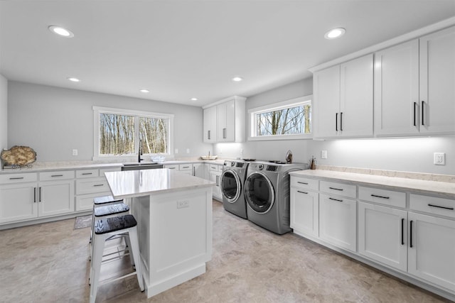 W7181 Duck Creek Ave, Westfield, WI 53964 - laundry area featuring cabinet space, separate washer and dryer, recessed lighting, and a sink