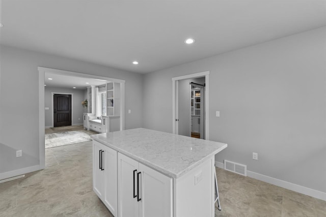 W7181 Duck Creek Ave, Westfield, WI 53964 - kitchen featuring a kitchen island, visible vents, light stone counters, white cabinets, and recessed lighting