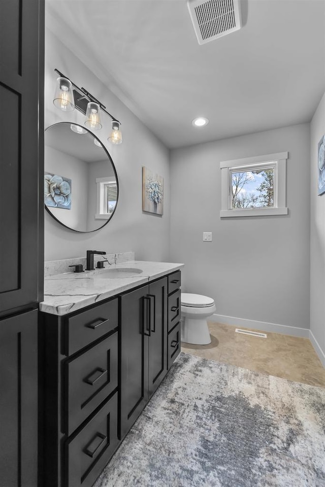 W7181 Duck Creek Ave, Westfield, WI 53964 - bathroom featuring visible vents, baseboards, toilet, and vanity
