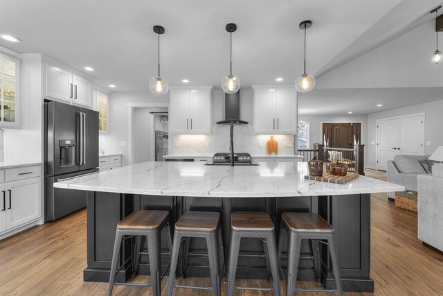 W7181 Duck Creek Ave, Westfield, WI 53964 - kitchen featuring wall chimney range hood, recessed lighting, white cabinets, and high quality fridge