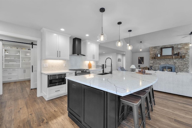 W7181 Duck Creek Ave, Westfield, WI 53964 - kitchen featuring white cabinets, a sink, built in microwave, wall chimney exhaust hood, and open floor plan