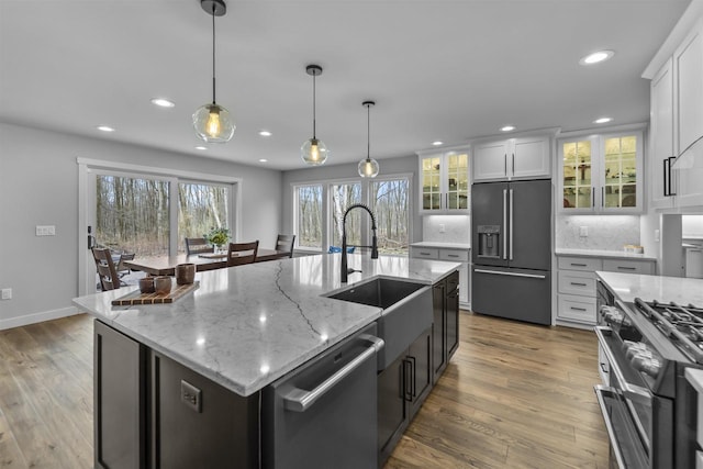 W7181 Duck Creek Ave, Westfield, WI 53964 - kitchen featuring white cabinets, appliances with stainless steel finishes, a sink, recessed lighting, and wood finished floors