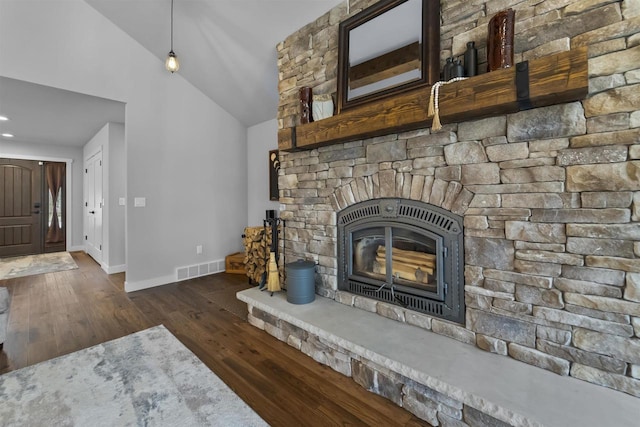 W7181 Duck Creek Ave, Westfield, WI 53964 - unfurnished living room featuring visible vents, wood finished floors, a fireplace, baseboards, and vaulted ceiling