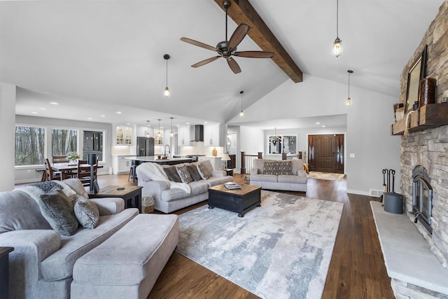 W7181 Duck Creek Ave, Westfield, WI 53964 - living area with dark wood-style flooring, beam ceiling, a fireplace, ceiling fan, and high vaulted ceiling