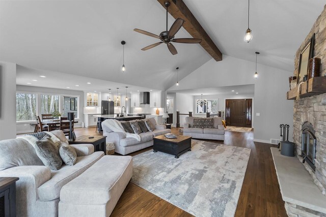 W7181 Duck Creek Ave, Westfield, WI 53964 - living room featuring ceiling fan, a fireplace, dark wood finished floors, high vaulted ceiling, and beamed ceiling