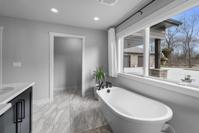 W7181 Duck Creek Ave, Westfield, WI 53964 - bathroom with a freestanding tub, baseboards, vanity, and a wealth of natural light