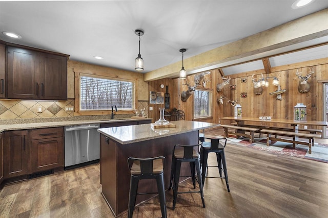 W7181 Duck Creek Ave, Westfield, WI 53964 - kitchen featuring stainless steel dishwasher, wood walls, wood finished floors, a kitchen island, and a sink