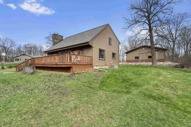 W7181 Duck Creek Ave, Westfield, WI 53964 - back of house featuring roof with shingles, a chimney, a yard, and a deck