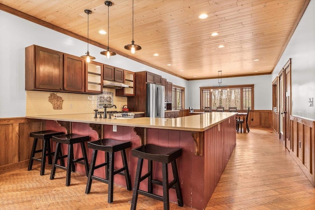 3853 County Rd E, Junction City, WI 54443 - kitchen featuring stainless steel refrigerator, wooden ceiling, wainscoting, a peninsula, and light countertops