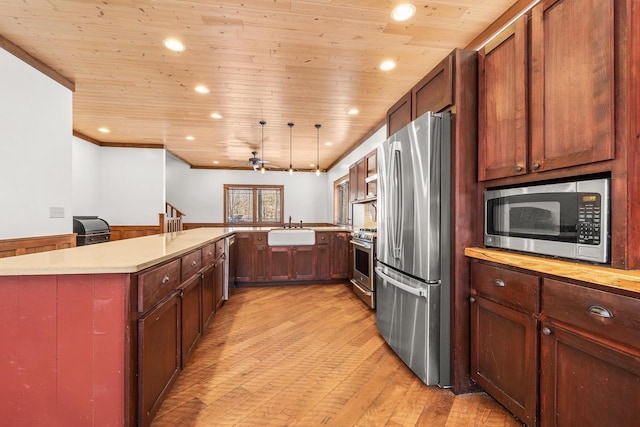 3853 County Rd E, Junction City, WI 54443 - kitchen with appliances with stainless steel finishes, a sink, wood ceiling, light wood finished floors, and light countertops