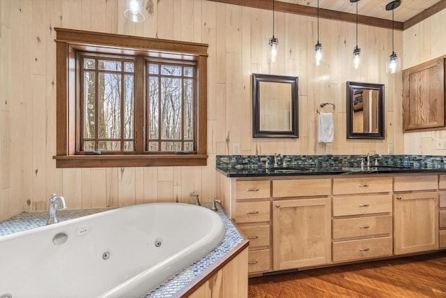3853 County Rd E, Junction City, WI 54443 - full bath with a whirlpool tub, wood walls, vanity, and wood finished floors