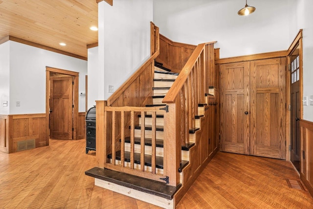 3853 County Rd E, Junction City, WI 54443 - stairs featuring a wainscoted wall, wood finished floors, wooden walls, recessed lighting, and wood ceiling