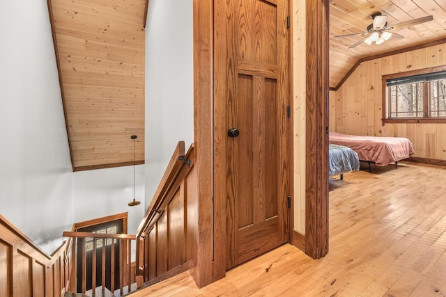 3853 County Rd E, Junction City, WI 54443 - staircase with wood ceiling, hardwood / wood-style floors, ceiling fan, wooden walls, and lofted ceiling