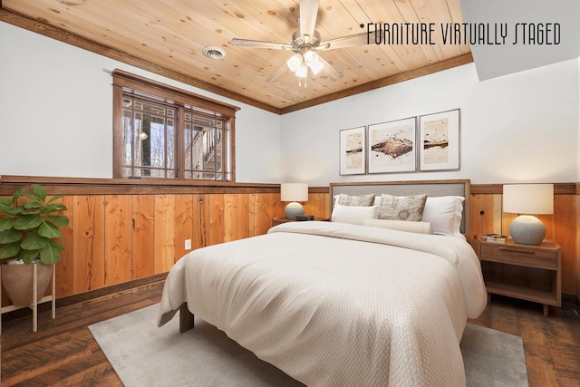 3853 County Rd E, Junction City, WI 54443 - bedroom with a wainscoted wall, wood ceiling, wooden walls, crown molding, and wood finished floors