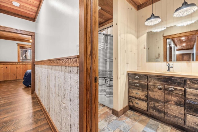 3853 County Rd E, Junction City, WI 54443 - ensuite bathroom featuring wooden walls, wainscoting, vanity, and wood ceiling